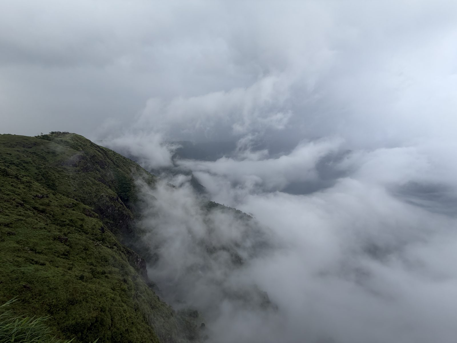 Clouds rolling over green hills